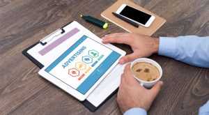 Business man with coffee looking at advertising portfolio