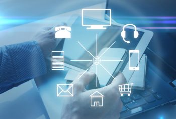 Hands with a tablet and different icons around. Omni channel